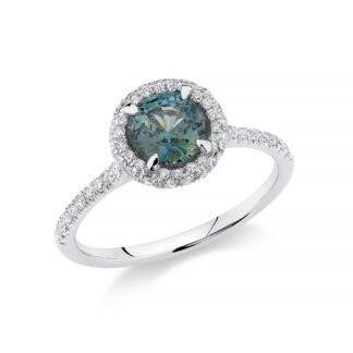 Platinum ring set with diamonds and an unheated teal sapphire